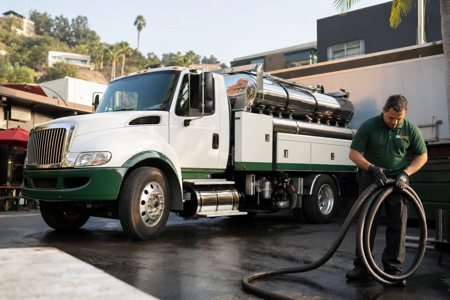 Free used cooking oil pickup at a La Habra Heights restaurant — unbranded white pump truck with hunter-green Oil Guyz technician