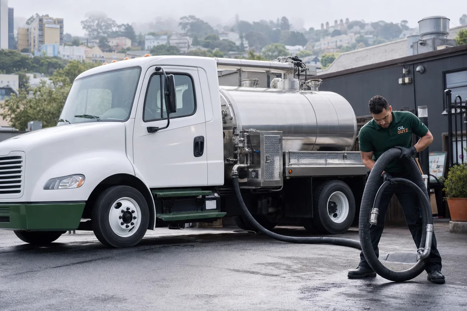 Free used cooking oil pickup at a Oakland restaurant — unbranded white pump truck with hunter-green Oil Guyz technician