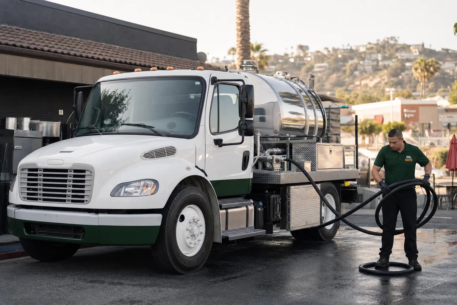 Free used cooking oil pickup at a Palos Verdes Estates restaurant — unbranded white pump truck with hunter-green Oil Guyz technician