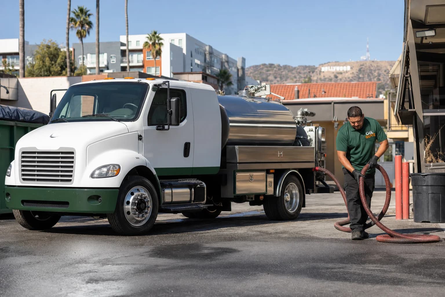 Free used cooking oil pickup at a San Gabriel restaurant — unbranded white pump truck with hunter-green Oil Guyz technician
