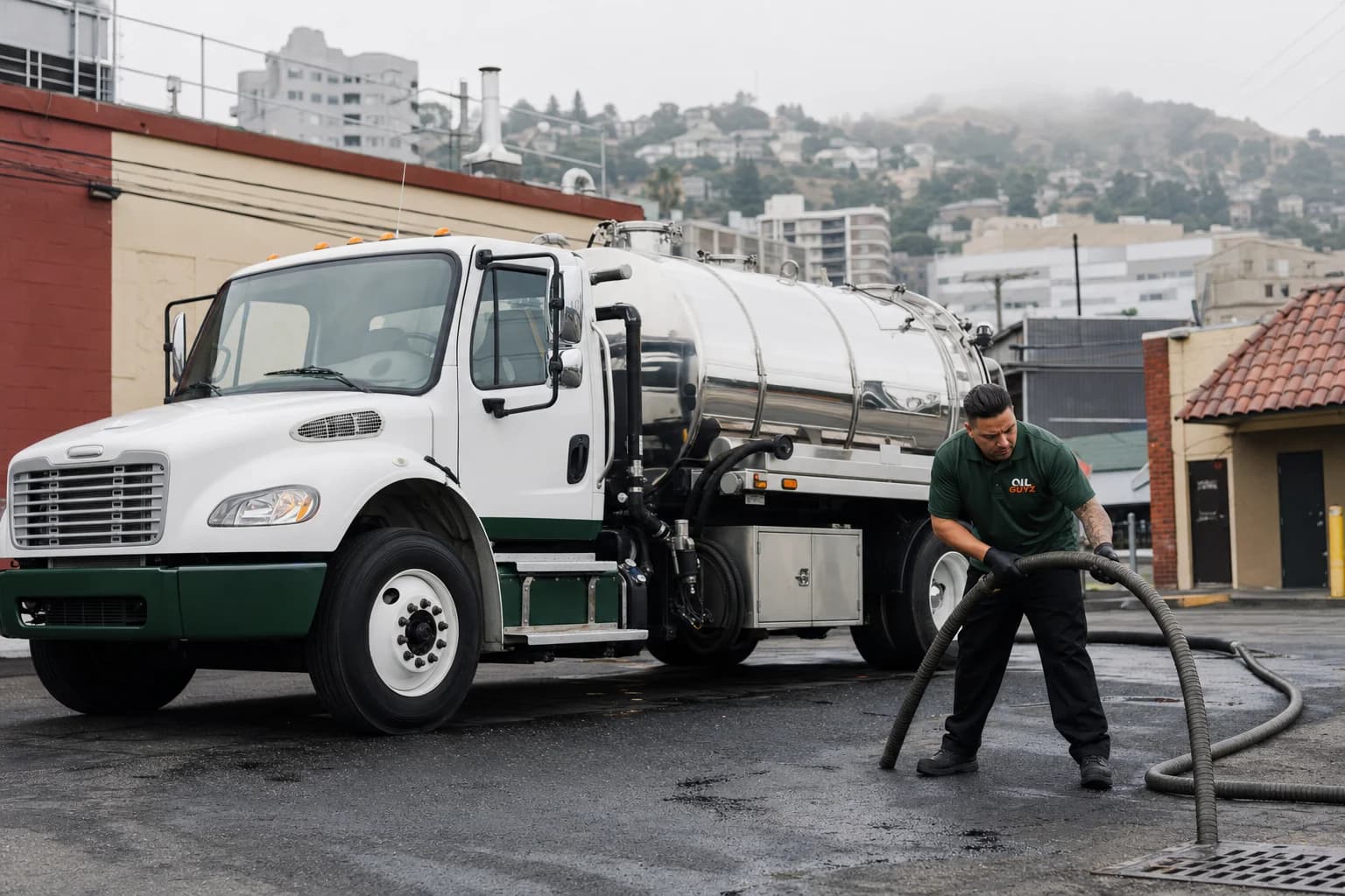 Free used cooking oil pickup at a San Leandro restaurant — unbranded white pump truck with hunter-green Oil Guyz technician